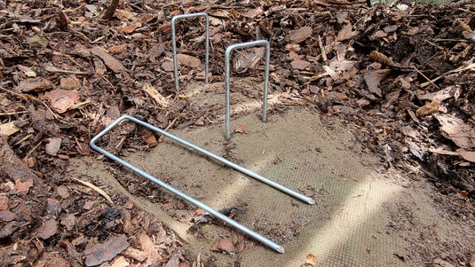 Securing pins for weed barrier